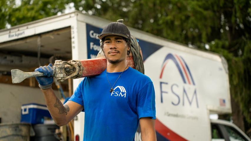 FSM crew member holding jackhammer.