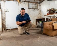 FSM employee inspecting basement after spring rain