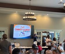 screen with the Foundation Systems of Michigan logo at the TPC Michigan Charity Classic