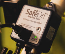 Close-up of a SafeDri sump pump system's enhanced float controller with a glowing green power light, ensuring peace of mind even when the sump pump alarm is going off.