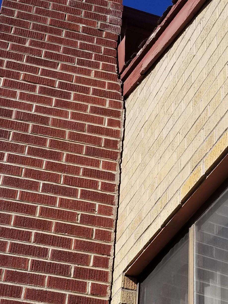 cracked brick chimney separating from house structure