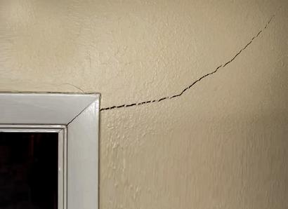 drywall crack on interior wall near door frame