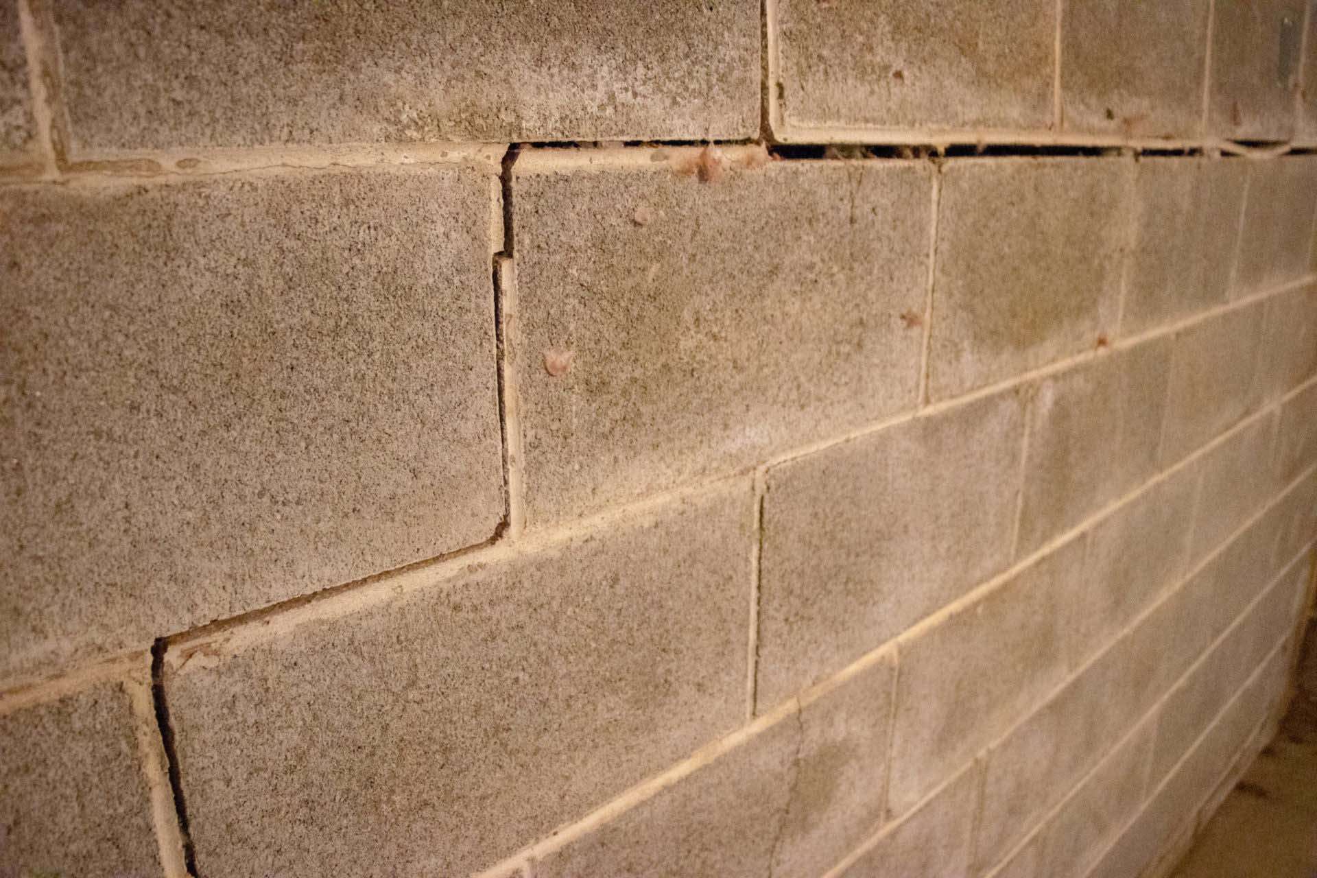 Stairstep crack in the cinderblock wall.