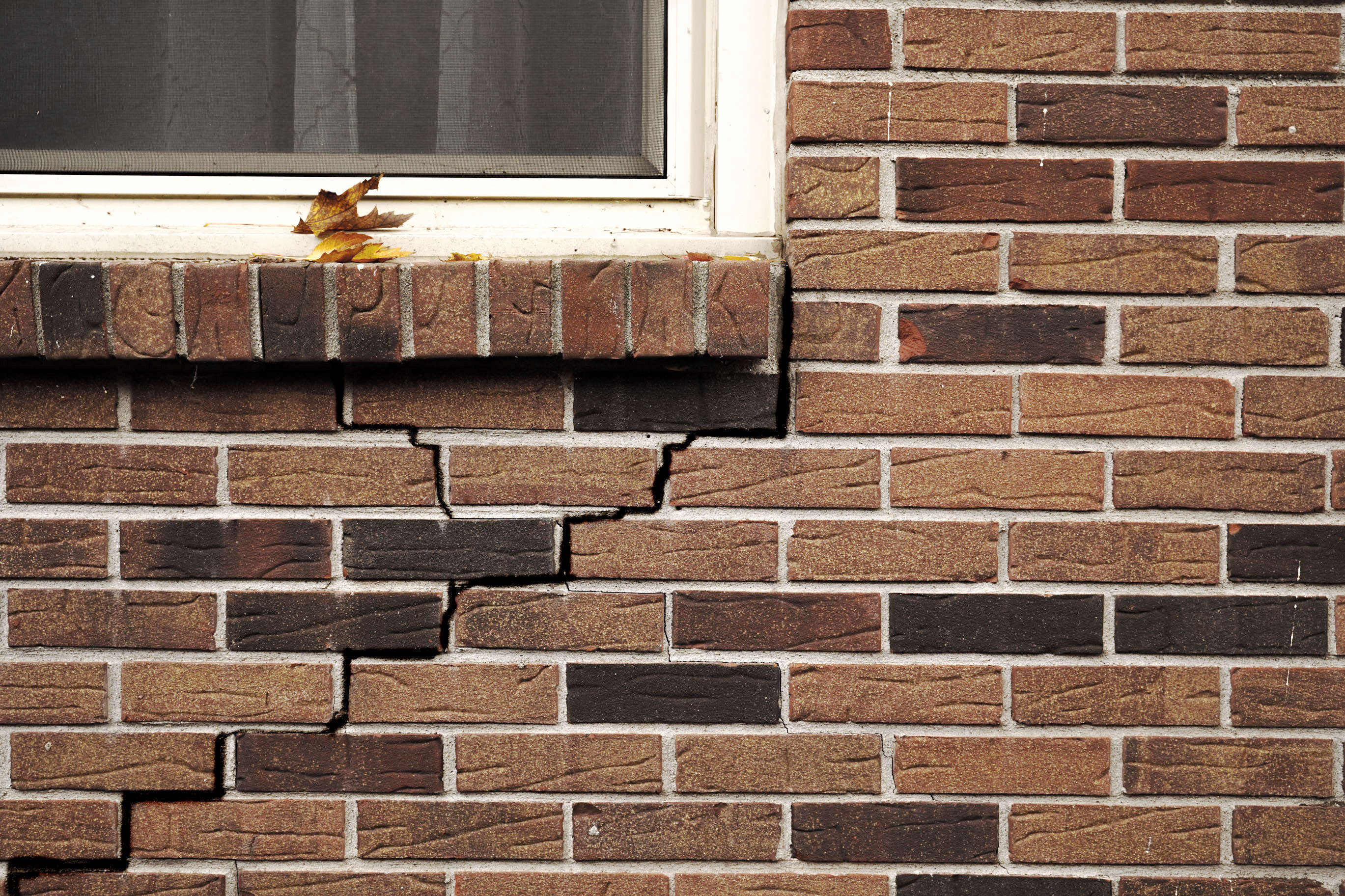 cracked brick on house near window