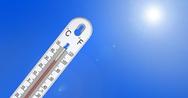 A thermometer, like the unpredictable patterns of shrink-swell soil, displays a high temperature under a bright blue sky and radiant sun.