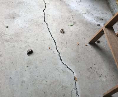 a cracked concrete floor with scattered debris