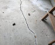 a cracked concrete floor with scattered debris