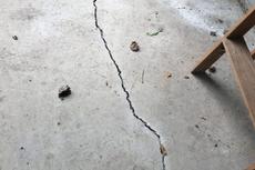 a cracked concrete floor with scattered debris