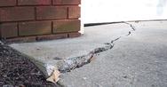 sinking concrete on the edge of a home with garage