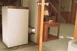 Dehumidifier in a basement, up against the wall keeping the space dry.