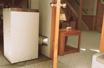 Dehumidifier in a basement, up against the wall keeping the space dry.
