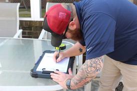 JES Foundation Repair inspector completing assessment paperwork