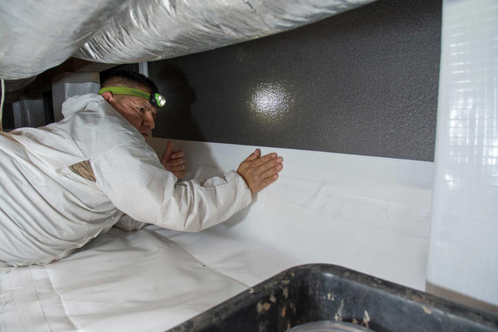 Crew installing Crawl Space Barrier