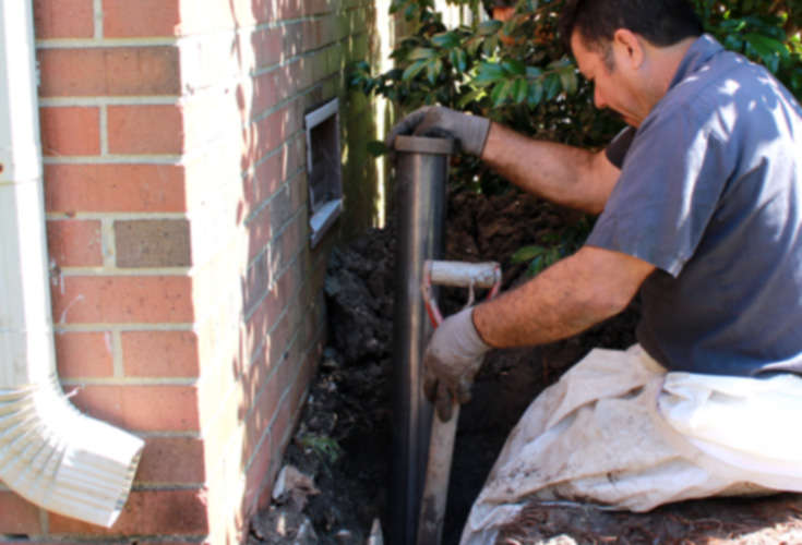 JES Foundation Repair team installing foundation piers on house