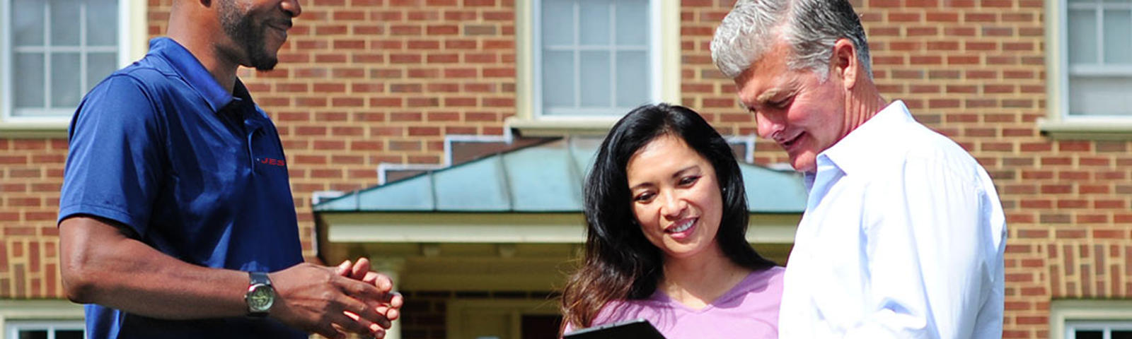JES CFI meeting with homeowner presenting solution outside