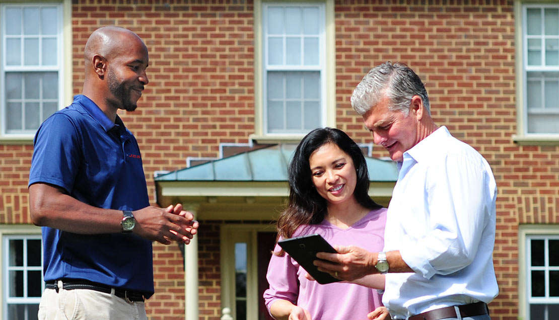 JES CFI meeting with homeowner presenting solution outside