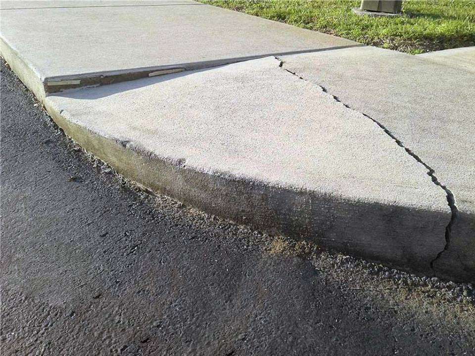 Cracked concrete sidewalk before polyrenewal lifting