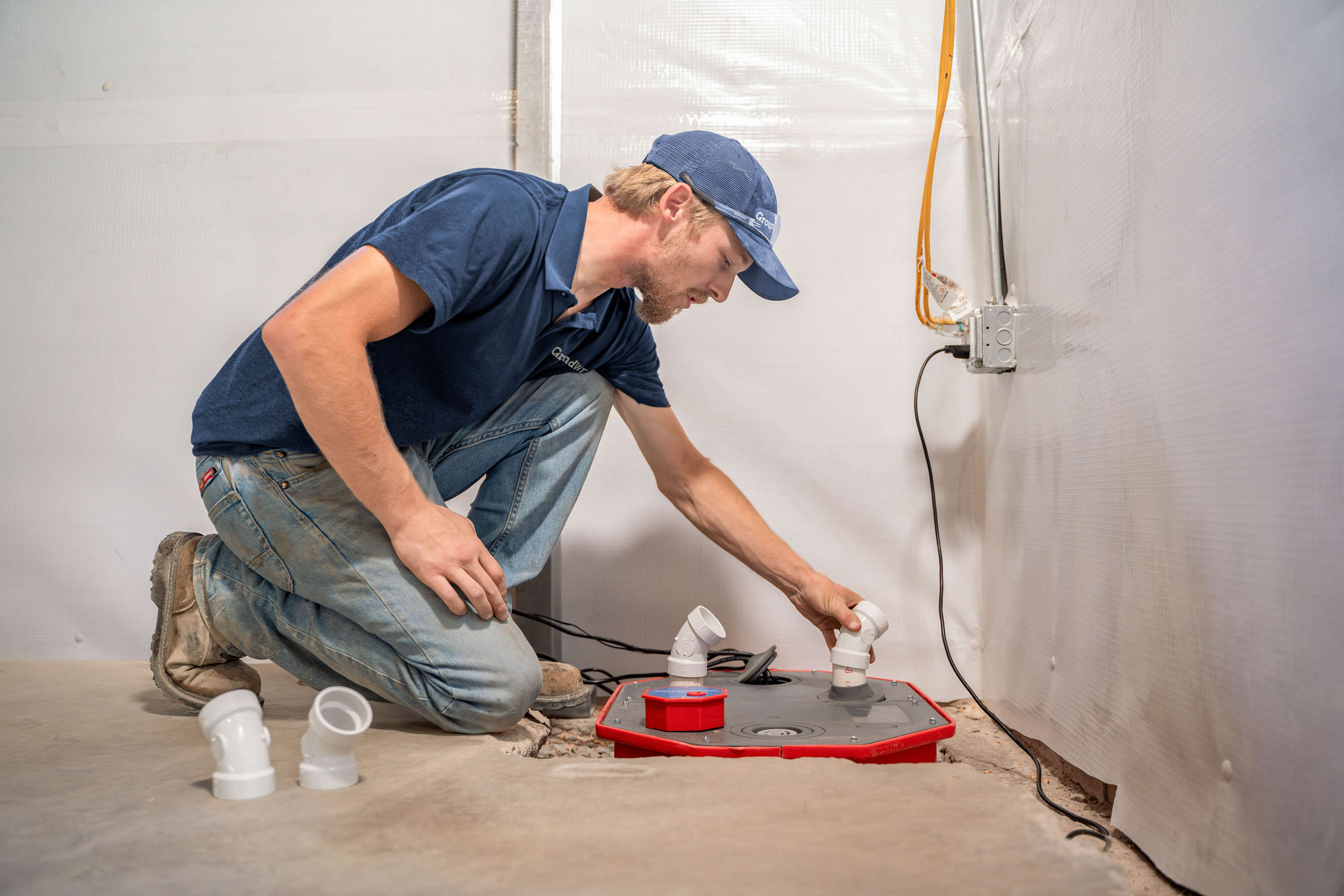 crew member installing a basement sump pump
