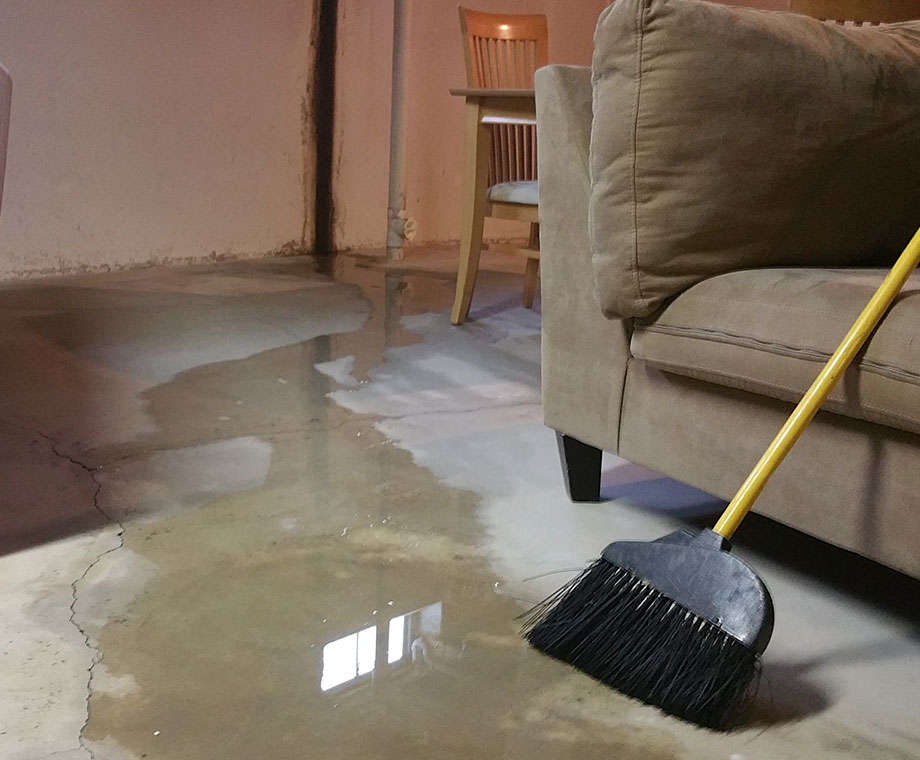 Inside of a leaking basement with standing water on floor