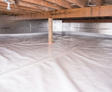 A well-maintained, sealed crawl space features plastic sheeting on the floor and reflective insulation on the walls. The choice between a 10 mil vs 15 mil vapor barrier ensures optimal protection against moisture, with tailored durability for your specific needs.