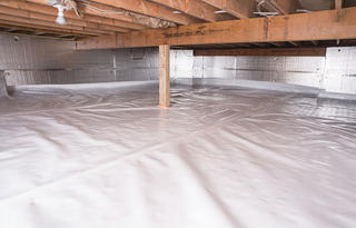 A well-maintained, sealed crawl space features plastic sheeting on the floor and reflective insulation on the walls. The choice between a 10 mil vs 15 mil vapor barrier ensures optimal protection against moisture, with tailored durability for your specific needs.