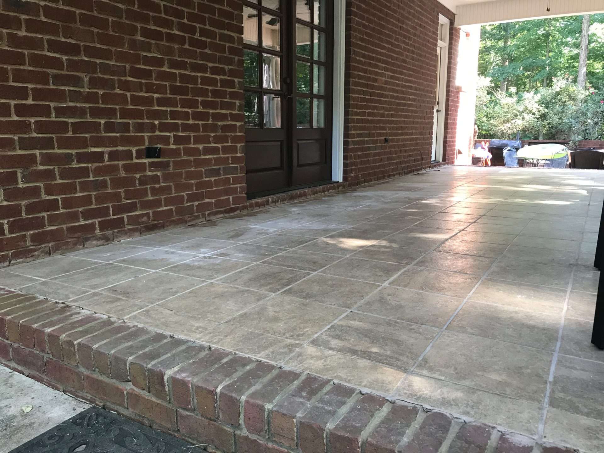 Concrete tile and brick patio after concrete leveling repair