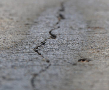 Cracked or separating concrete close up