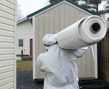 Crew carrying vapor barrier for installation