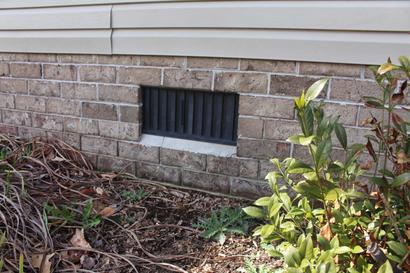 an exterior view of a crawl space vent