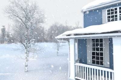 snow falling on house