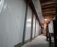 wall beams installed over a basement wall vapor barrier