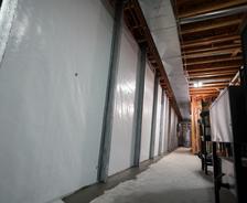 wall beams installed over a basement wall vapor barrier