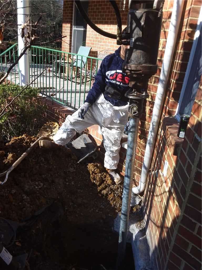 Crew installing helical piers