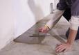 Crew waterproofing basement floors.