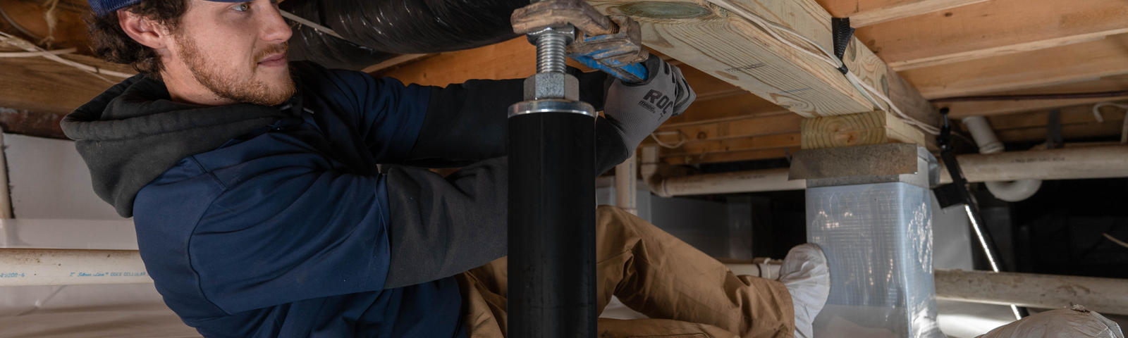 crew member installs intellijacks in crawl space