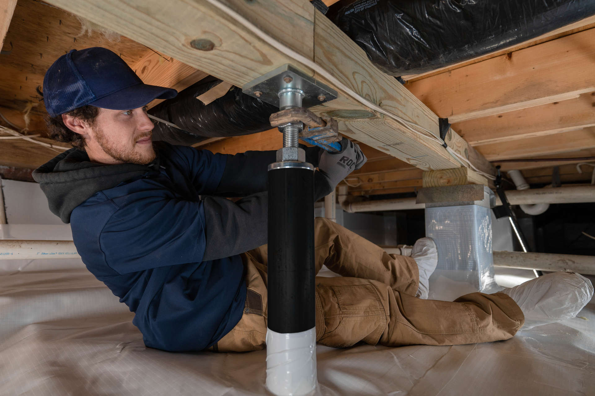 crew member installs intellijacks in crawl space
