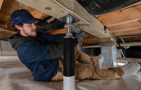 crew member installs intellijacks in crawl space