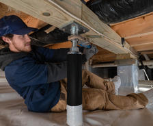 crew member installs intellijacks in crawl space