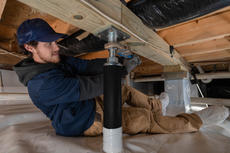 crew member installs intellijacks in crawl space