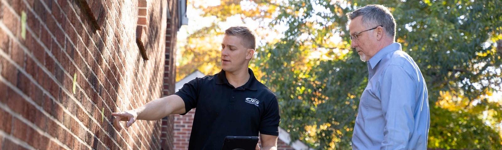 JES CFI foundation inspection on exterior brick wall.