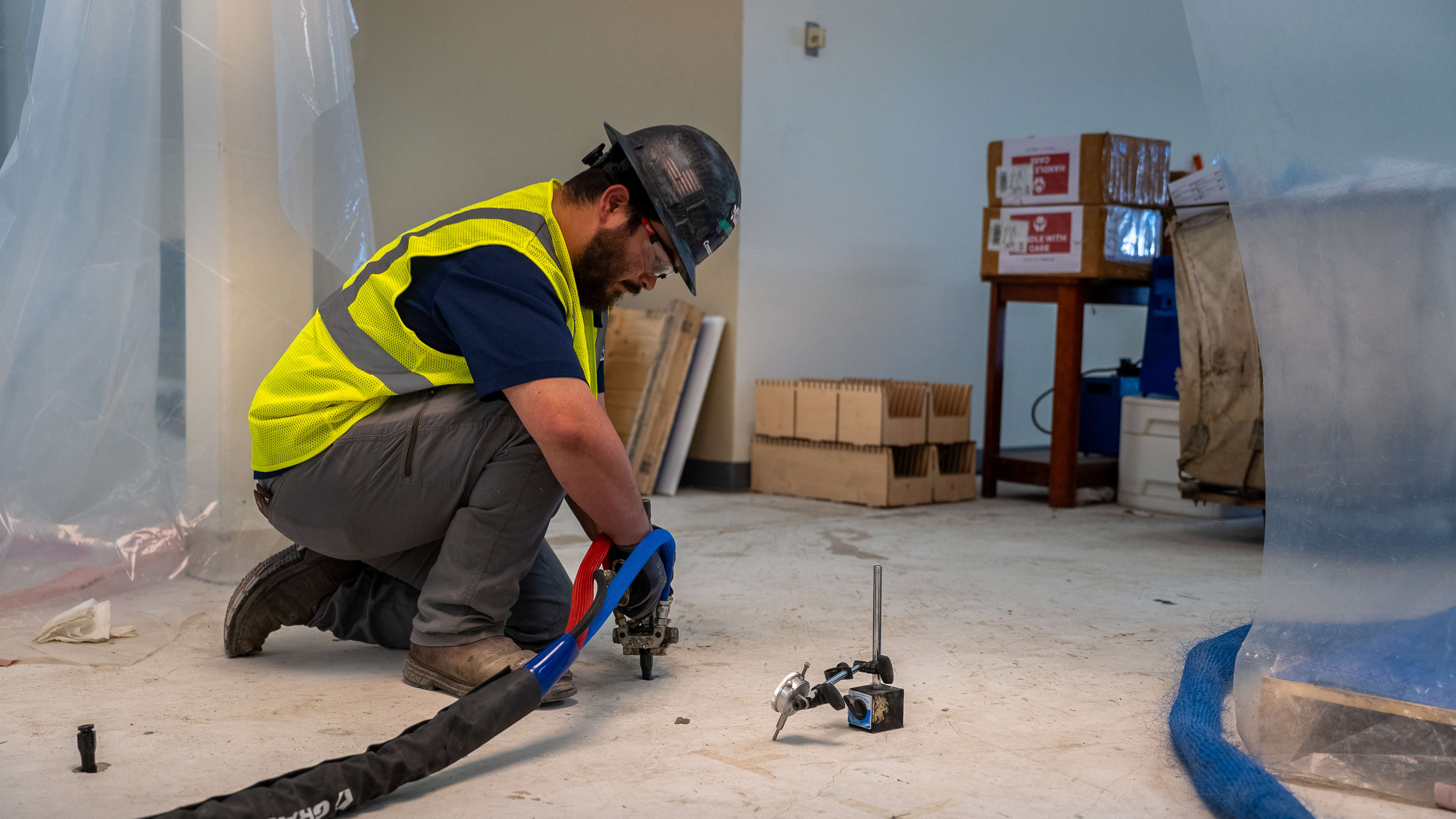 crew member installs polyrenewal polyurethane foam for commercial concrete lifting