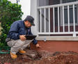 A JES technician inspects a settled foundation.