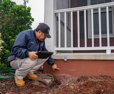 A JES technician inspects a settled foundation.