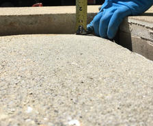 person measuring a sinking porch slab