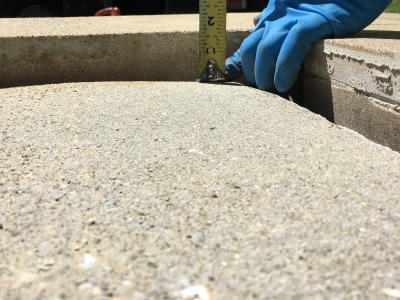 person measuring a sinking porch slab