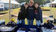 Three JES Foundation Repair crew members at sponsorship booth at Youth For Tomorrow's Country Fair & Auction