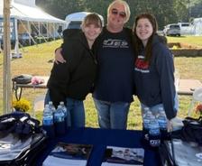 Three JES Foundation Repair crew members at sponsorship booth at Youth For Tomorrow's Country Fair & Auction