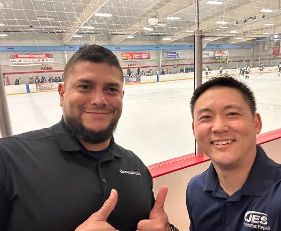 Two JES Foundation Repair crew members at Ashburn Ice House rink