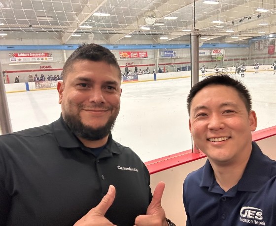 Two JES Foundation Repair crew members at Ashburn Ice House rink