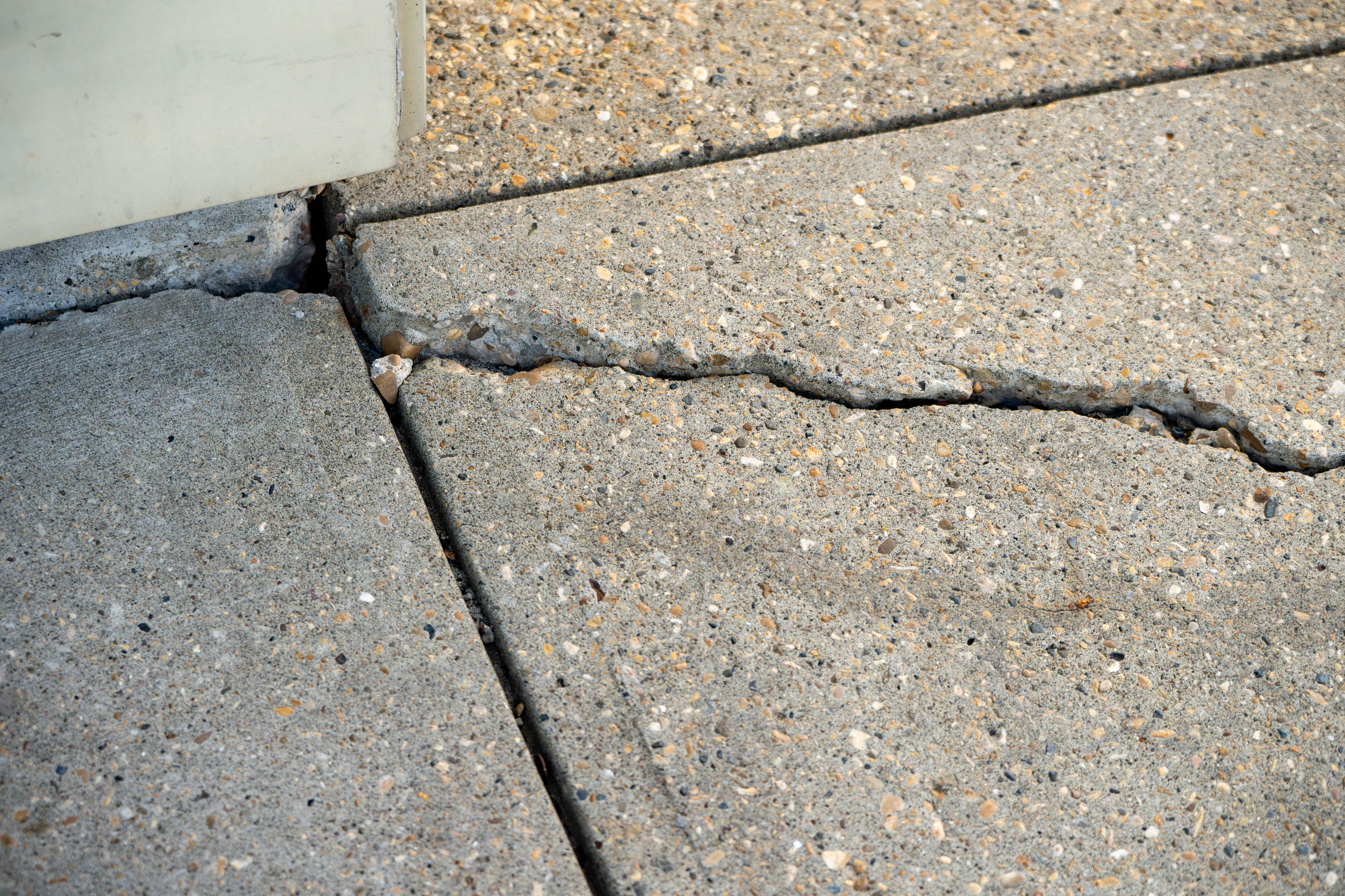 Cracks in the corner of a concrete sidewalk